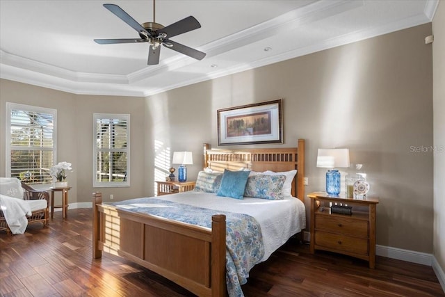 bedroom with dark hardwood / wood-style floors, a raised ceiling, ceiling fan, and ornamental molding