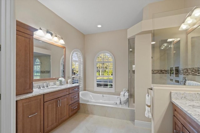 bathroom with tile patterned flooring, vanity, and independent shower and bath