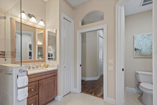 bathroom featuring hardwood / wood-style flooring, vanity, and toilet