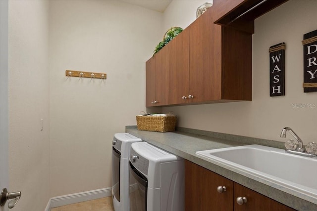 washroom featuring separate washer and dryer, sink, and cabinets