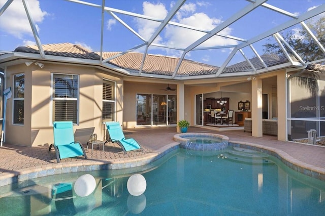 back of property featuring a lanai, a patio area, ceiling fan, and a swimming pool with hot tub