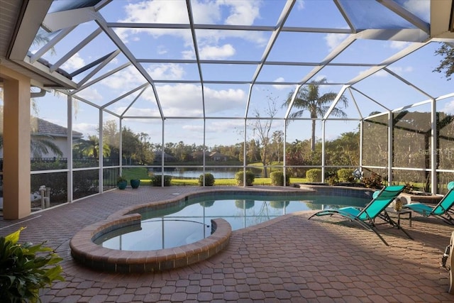 view of swimming pool with a lanai, a water view, and a patio