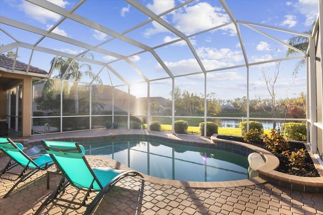 view of pool with a lanai, a water view, and a patio