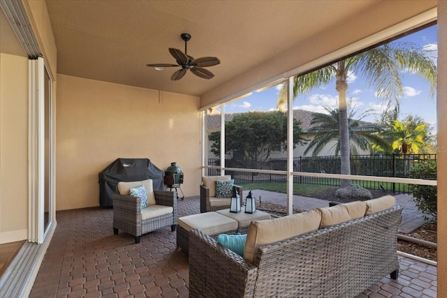 sunroom / solarium featuring ceiling fan