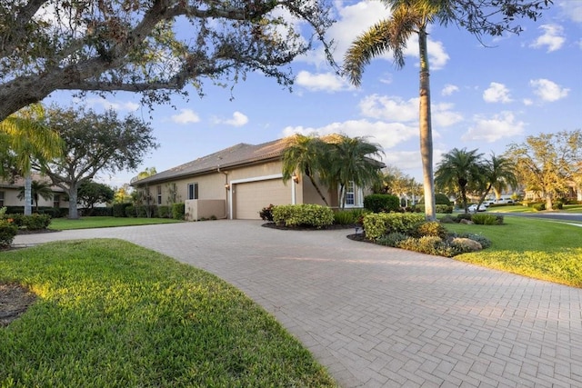 view of front of home featuring a garage and a front yard