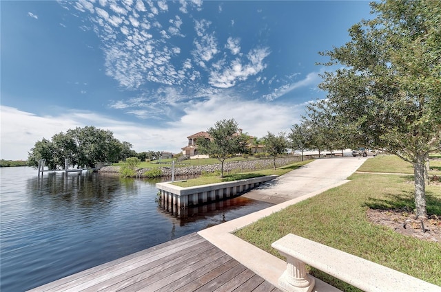 dock area featuring a water view and a yard