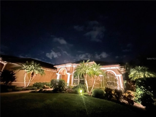 mediterranean / spanish house with a lawn