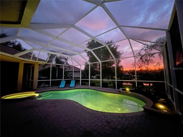 pool at dusk with a lanai