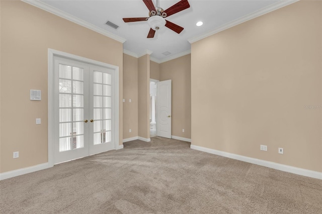 empty room with ceiling fan, ornamental molding, light carpet, and french doors