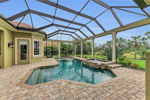 view of pool with an in ground hot tub, glass enclosure, and a patio area