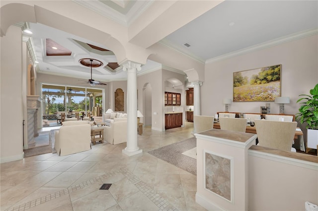 tiled living room with ornate columns, ceiling fan, and ornamental molding