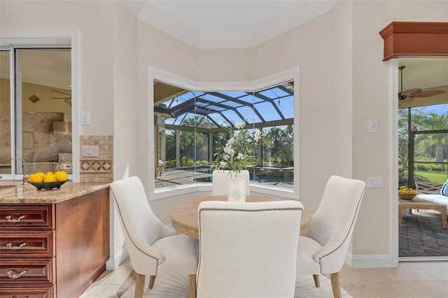 dining area with light tile patterned floors and crown molding