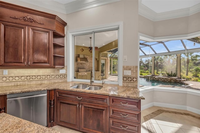 kitchen with dishwasher, sink, tasteful backsplash, light stone counters, and light tile patterned flooring