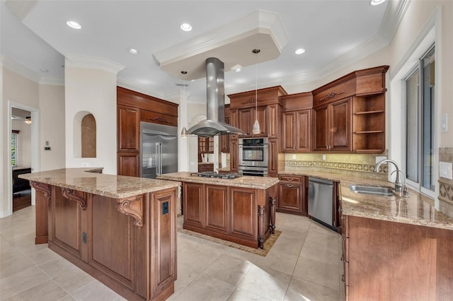 kitchen with sink, stainless steel appliances, kitchen peninsula, island exhaust hood, and decorative light fixtures