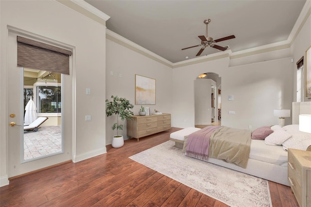 bedroom with ceiling fan, dark wood-type flooring, and ornamental molding