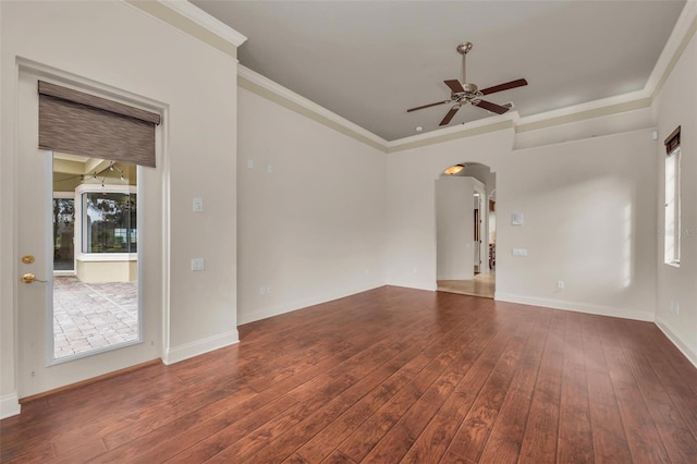 unfurnished room with dark hardwood / wood-style flooring, plenty of natural light, ceiling fan, and crown molding