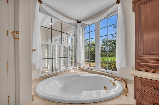 bathroom with plenty of natural light and a bath