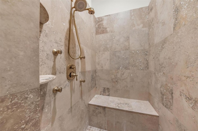 bathroom with a tile shower