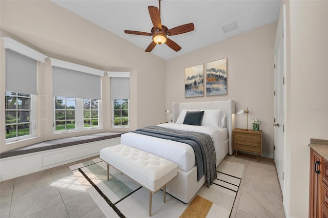 tiled bedroom featuring ceiling fan