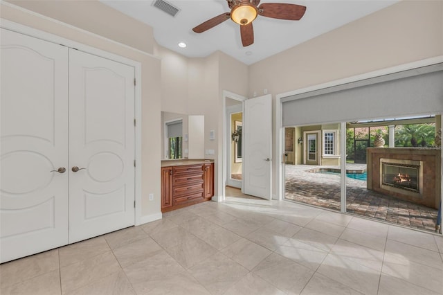 unfurnished bedroom with light tile patterned floors and ceiling fan