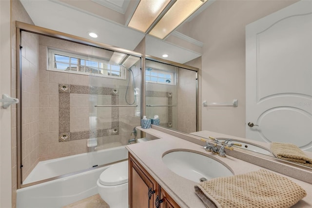 full bathroom featuring vanity, toilet, shower / bath combination with glass door, and crown molding