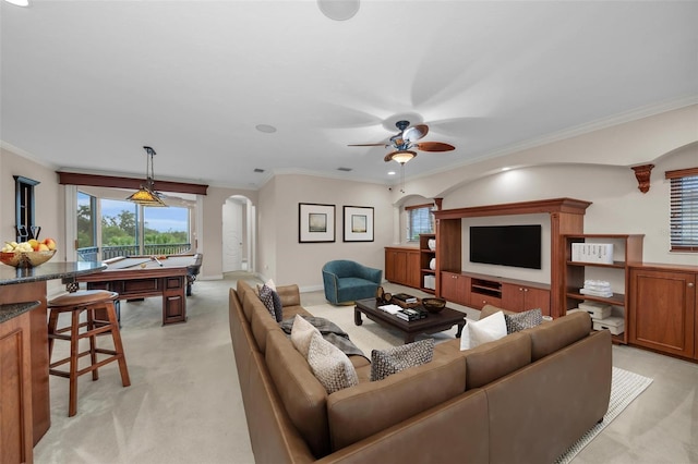 living room featuring ceiling fan, light colored carpet, crown molding, and billiards