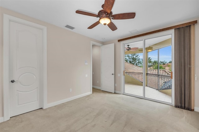 spare room featuring ceiling fan and light colored carpet