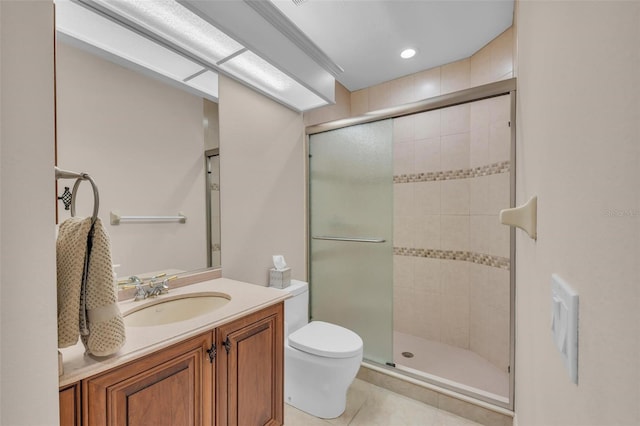 bathroom featuring tile patterned floors, vanity, toilet, and walk in shower