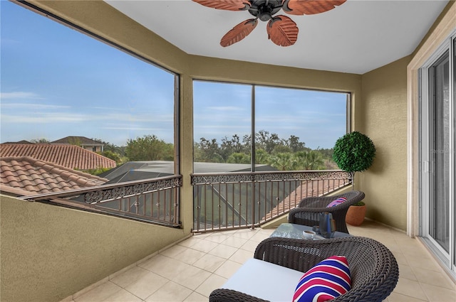 sunroom / solarium featuring ceiling fan and plenty of natural light