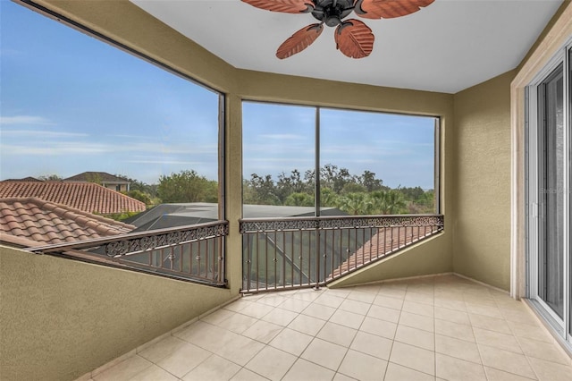 unfurnished sunroom with ceiling fan