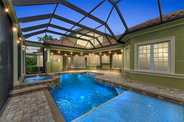 view of pool featuring a lanai and an in ground hot tub