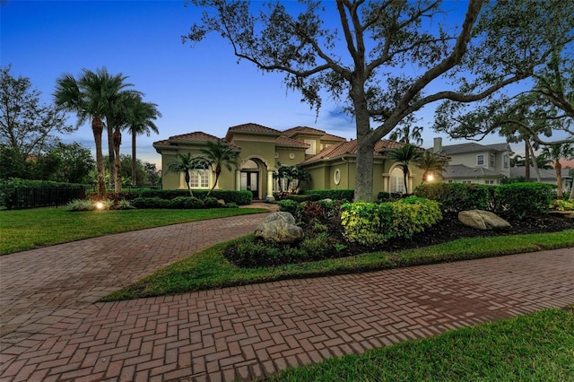 mediterranean / spanish house with a front yard