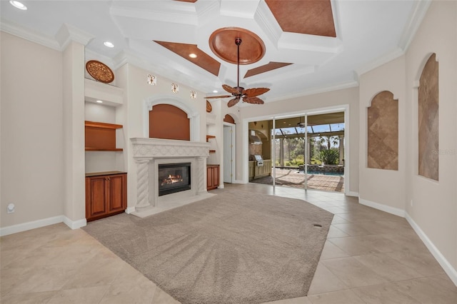 unfurnished living room with ornamental molding, a premium fireplace, coffered ceiling, and built in features