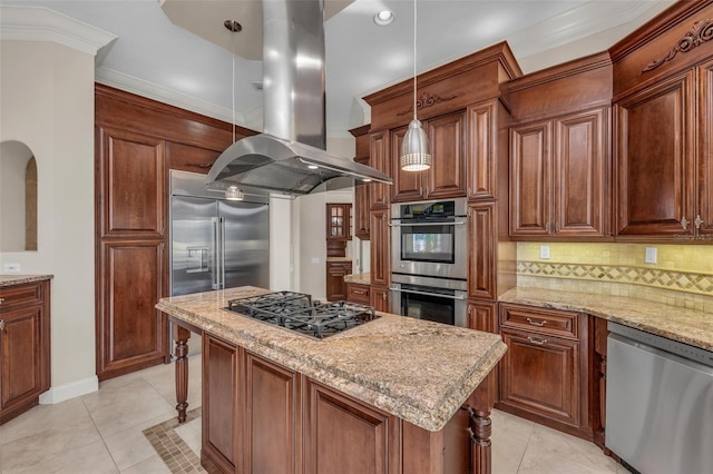 kitchen with hanging light fixtures, stainless steel appliances, light stone counters, island exhaust hood, and a kitchen island