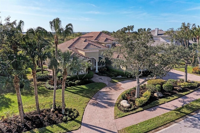 mediterranean / spanish home featuring a front yard