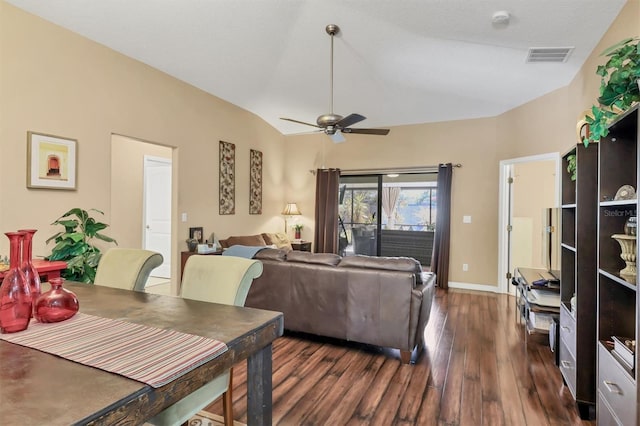 living room featuring a textured ceiling, dark wood-type flooring, ceiling fan, and lofted ceiling