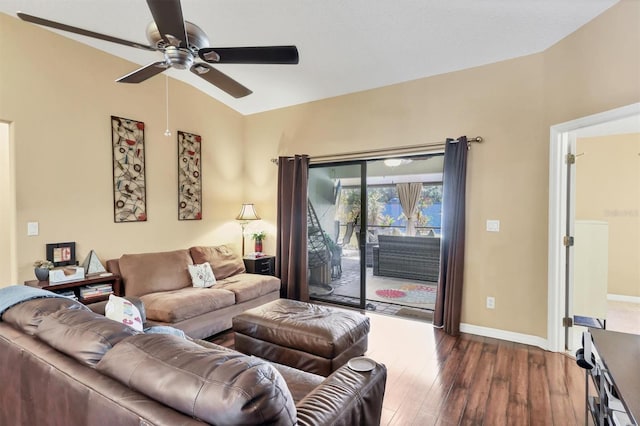 living room featuring vaulted ceiling, ceiling fan, and dark wood-type flooring