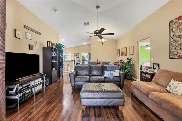 living room with dark hardwood / wood-style floors, ceiling fan, lofted ceiling, and a textured ceiling