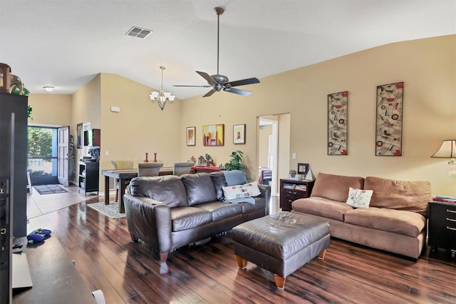 living room featuring ceiling fan with notable chandelier, dark hardwood / wood-style flooring, and high vaulted ceiling