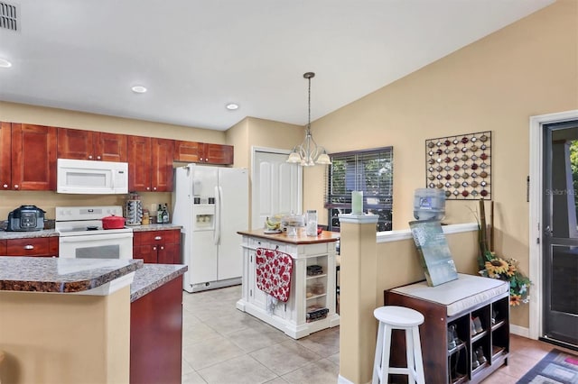 kitchen featuring hanging light fixtures, a chandelier, vaulted ceiling, white appliances, and light tile patterned flooring