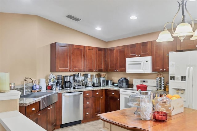 kitchen featuring white appliances, sink, hanging light fixtures, vaulted ceiling, and light stone countertops