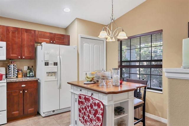 kitchen featuring pendant lighting, white appliances, vaulted ceiling, light tile patterned floors, and a chandelier