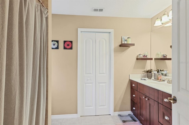 bathroom with tile patterned flooring and vanity