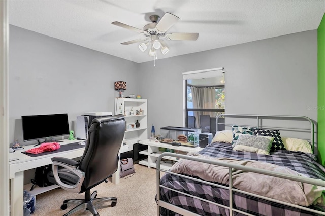 carpeted bedroom with ceiling fan and a textured ceiling