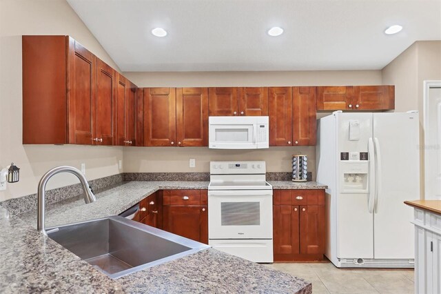 kitchen with recessed lighting, white appliances, a sink, and light tile patterned floors