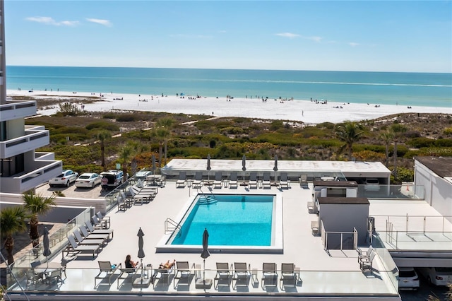 birds eye view of property featuring a view of the beach and a water view