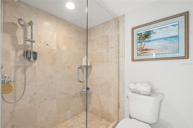 bathroom with toilet and an enclosed shower