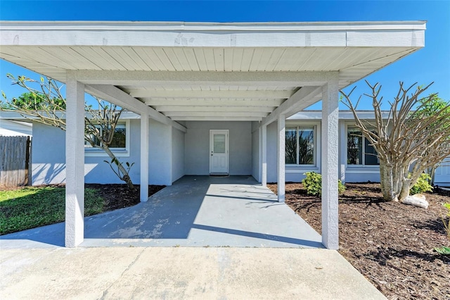 view of exterior entry featuring a carport