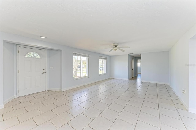 tiled foyer entrance featuring ceiling fan