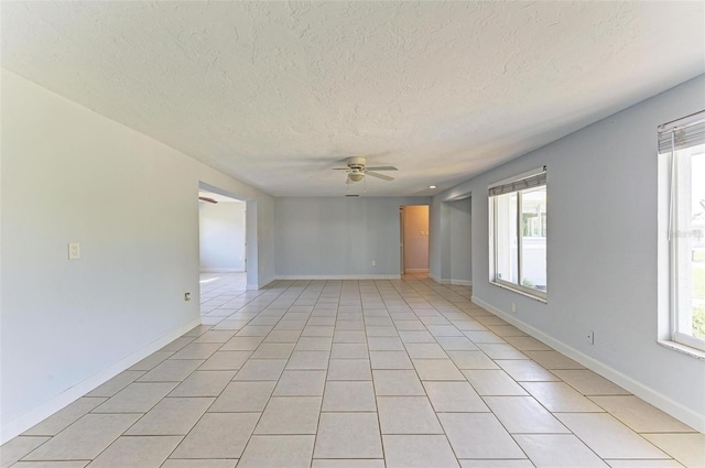 tiled spare room featuring ceiling fan and a textured ceiling